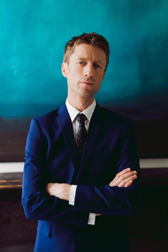 Sammy J in a navy suit